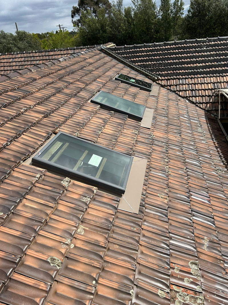 Roof with two skylights and a tiled roof surface - Bill Roofing 