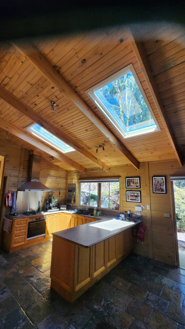 Wooden kitchen with skylights and stone flooring - Bill Roofing 